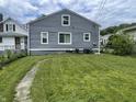 The back exterior of the home shows gray siding, white trim, and a well-maintained lawn at 3636 Crescent Ave, Indianapolis, IN 46208