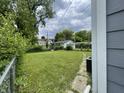 Expansive backyard with a well-maintained lawn, mature trees, and chain link fence at 3636 Crescent Ave, Indianapolis, IN 46208
