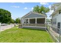 The exterior view shows a well-manicured lawn, porch, and charming curb appeal at 3636 Crescent Ave, Indianapolis, IN 46208