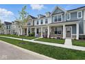Street view of townhomes with well-kept lawns at 3931 Wren Dr, Brownsburg, IN 46112