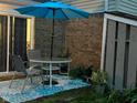 Cozy patio featuring an outdoor dining set, stylish rug, and brick backdrop at 3984 Braddock Rd, Indianapolis, IN 46268