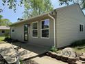 Side view of home with a concrete walkway, well-manicured yard, and welcoming front door; perfect for outdoor enjoyment at 409 Parkway St, Whiteland, IN 46184