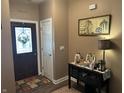 Inviting foyer with decorative console table, warm wall colors, and a welcoming atmosphere at 4920 E Daisy Ln, Mooresville, IN 46158