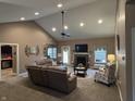 Spacious living room featuring a vaulted ceiling, cozy fireplace, and comfortable seating area at 4920 E Daisy Ln, Mooresville, IN 46158