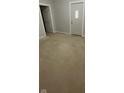 Neutral colored living room featuring carpeted floors, freshly painted walls, and two doors at 5 E Jefferson St, Maxwell, IN 46154
