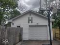 Detached garage with basketball hoop and a prominent 'H' on its facade, offering ample parking at 513 Andover Rd, Anderson, IN 46013