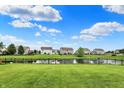 Beautiful backyard with a serene pond and a well-maintained lawn at 5598 W Woodstock Trl, McCordsville, IN 46055