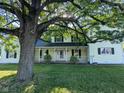 Charming two-story home with a welcoming front porch, white railings, and a well-manicured lawn at 6336 N Carroll Rd, Indianapolis, IN 46235