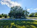 A well-maintained home with mature trees in front and a large front yard at 6336 N Carroll Rd, Indianapolis, IN 46235