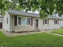 Charming single-story home with gray siding, red shutters, and a green lawn at 720 Henry St, Lebanon, IN 46052