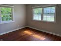 Cozy bedroom featuring hardwood floors and sun-filled double windows at 10328 Central Ave, Carmel, IN 46280