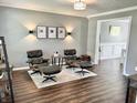 Comfortable living room with hardwood floors, accent lighting and designer chairs at 10847 Woodlook Ln, Indianapolis, IN 46239
