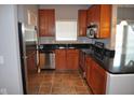 Bright kitchen features stainless steel appliances, dark countertops, and ample cabinet space at 12860 University Cres # 1B, Carmel, IN 46032