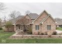 Stunning brick home featuring well-maintained landscaping and a welcoming entrance at 1344 S Fox Paw Dr, New Palestine, IN 46163