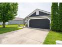 Charming single Gathering home with a well-manicured lawn, brick accents, and an attached two-car garage at 1414 Dowell St, Greenwood, IN 46143