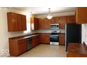Spacious kitchen with stainless steel appliances and wood cabinets at 14170 Royalwood Dr, Fishers, IN 46037