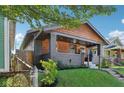Craftsman-style home with inviting front porch, landscaping, and a fenced yard at 1421 S New Jersey St, Indianapolis, IN 46225