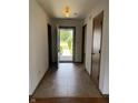 Bright foyer featuring tile flooring and view to landscaped front yard through an open front door at 1562 Prairieview Ln, Greenfield, IN 46140