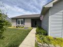 Inviting front of a single-story home with brick facade and tidy landscaping leading to the entrance at 1562 Prairieview Ln, Greenfield, IN 46140