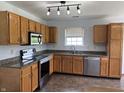 Traditional kitchen with oak cabinets, granite countertops, and stainless steel appliances at 1562 Prairieview Ln, Greenfield, IN 46140