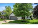 Suburban home with a well-maintained lawn, a grey garage, and nice landscaping at 17841 Grassy Knoll Dr, Westfield, IN 46074
