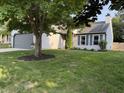 View of a well-maintained single-Gathering home with a gray garage door and mature trees at 17841 Grassy Knoll Dr, Westfield, IN 46074