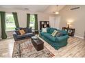 Inviting living room with large windows, wood floors, and comfortable seating for entertaining guests at 17841 Grassy Knoll Dr, Westfield, IN 46074