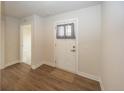 Bright entryway featuring wood-look flooring, neutral walls, and a modern front door at 1863 River Birch Dr, Greenfield, IN 46140
