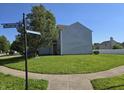 Corner lot featuring a well-manicured lawn and mature trees at 2248 Salem Park Dr, Indianapolis, IN 46239