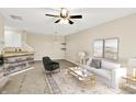 Bright living room with ceiling fan, neutral walls, open space, and stylish decor at 2306 Brightwell Pl, Indianapolis, IN 46260