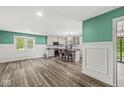 Open concept kitchen showcasing center island with bar stool seating and an adjacent dining area at 2346 N State Road 39, Danville, IN 46122