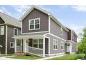 Attractive two-story home with brown siding, white trim, covered front porch, and landscaped surroundings at 2417 N Rural N Ave, Indianapolis, IN 46218