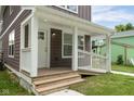 Cozy front porch featuring white railings, wood steps, and a charming entrance to the home at 2417 N Rural N Ave, Indianapolis, IN 46218