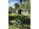 Backyard with a well-maintained lawn and trees at 2421 N Arsenal Ave, Indianapolis, IN 46218
