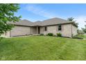 Well-maintained brick home with manicured lawn and garden beds in a suburban neighborhood at 2422 Oak Dr, Clayton, IN 46118