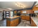Traditional kitchen features wooden cabinets, granite countertops, and a functional center island at 3105 E Banta Rd, Indianapolis, IN 46227