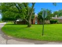Street view of brick home with green lawn and mature trees next to a Colorado street sign at 3602 N Colorado Ave, Indianapolis, IN 46218
