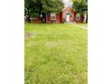 Beautifully maintained front yard with lush green grass leading to a brick home at 3602 N Colorado Ave, Indianapolis, IN 46218