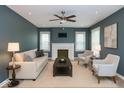 Cozy living room with fireplace, neutral furniture, and bright natural light at 3602 N Colorado Ave, Indianapolis, IN 46218