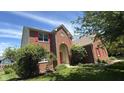 Charming brick home featuring a well-maintained lawn, red shutters and a covered entry at 404 Joseph Way, Carmel, IN 46032
