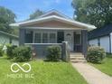 Charming one-story home with a tidy front lawn and a welcoming front porch at 4325 Norwaldo Ave, Indianapolis, IN 46205
