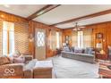 Inviting living room featuring wood paneled walls and a comfortable seating area at 445 N 13Th Ave, Beech Grove, IN 46107
