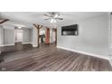 Spacious living room with hardwood floors, brick columns, and a modern ceiling fan at 5312 E Southern Ave, Indianapolis, IN 46203