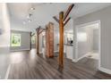 Inviting living room with hardwood floors, brick columns, and an open layout perfect for entertaining at 5312 E Southern Ave, Indianapolis, IN 46203