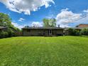 Well-maintained backyard with lush green grass and a cozy deck, perfect for outdoor relaxation and entertaining at 5558 Bertha St, Indianapolis, IN 46241