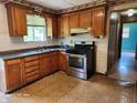 Traditional style kitchen featuring wood cabinets and modern stainless steel appliances at 5558 Bertha St, Indianapolis, IN 46241
