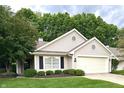 Inviting single-story home showcasing a well-maintained lawn and cozy front entrance, perfect for curb appeal at 6366 Stratford N Dr, Fishers, IN 46038
