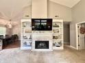 Spacious living room showcasing a fireplace, custom shelving, and plenty of natural light, perfect for entertaining at 6366 Stratford N Dr, Fishers, IN 46038