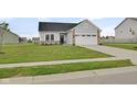 Charming single-Gathering home featuring a two-car garage, manicured lawn, and stylish gray siding at 637 N Quartz Ln, Fortville, IN 46040