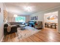 Inviting living room featuring hardwood floors, a large window, and stylish furnishings at 6799 Lakeshore Dr, Avon, IN 46123